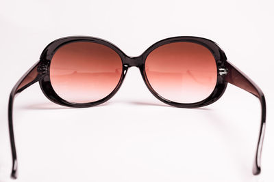 Close-up of sunglasses against white background