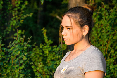 Portrait of beautiful young woman looking away