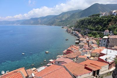 High angle view of townscape by sea against sky