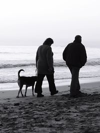 Rear view of man standing on beach