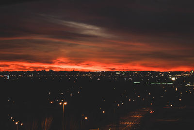 High angle view of illuminated buildings against sky at night