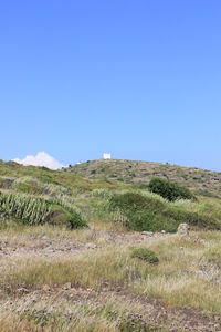 Scenic view of land against clear blue sky