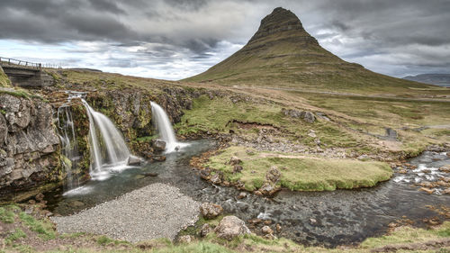 Scenic view of waterfall against sky