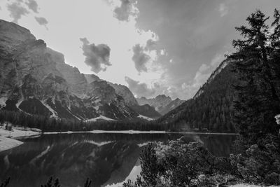 Scenic view of lake by mountains against sky