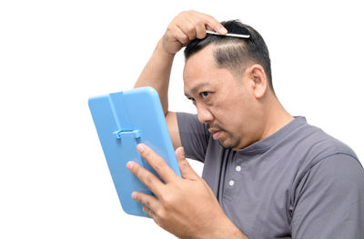 Man using smart phone against white background