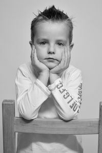 Portrait of cute boy sitting at home