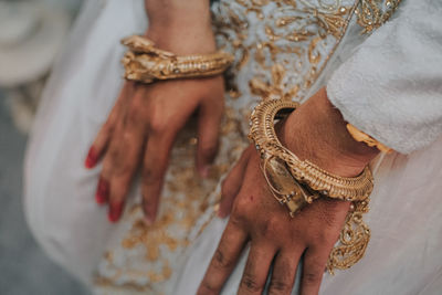 Midsection of woman wearing jewelry