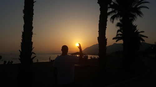 Silhouette of people at beach during sunset