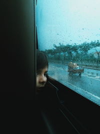 Portrait of man seen through car window