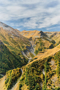 Vertical frame, view of  gorge with a waterfall from the mountain plateau, autumn in the mountains