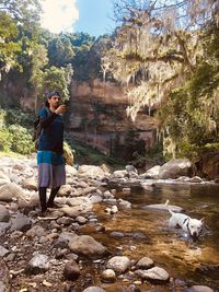 Rear view of woman standing on rock