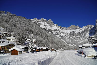 Snow covered mountains against clear blue sky