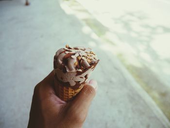 Close-up of hand holding ice cream cone