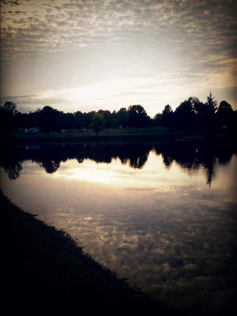 water, reflection, silhouette, sunset, tranquil scene, tranquility, lake, scenics, sky, beauty in nature, tree, nature, idyllic, dusk, standing water, calm, cloud - sky, waterfront, outdoors, cloud