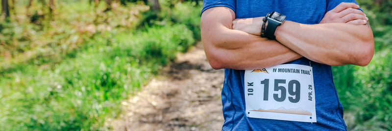 Midsection of man holding text on field