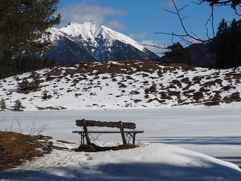 Scenic view of snow covered field against sky
