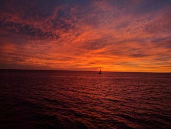 Scenic view of sea against orange sky