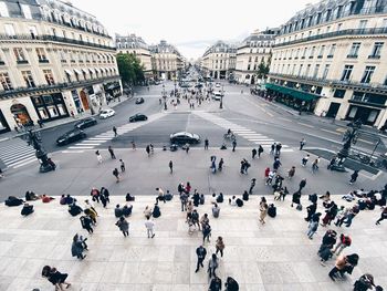 High angle view of people walking on paris avenue de opera with perspective 