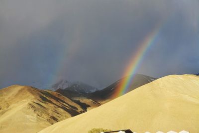 Rainbow over mountain against sky
