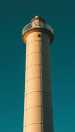 Low angle view of lighthouse against clear blue sky