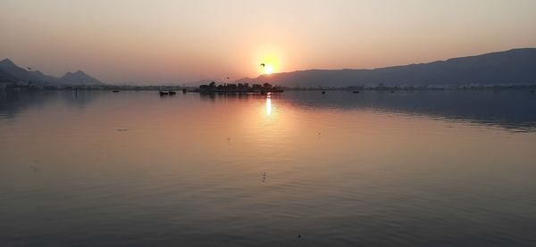 Scenic view of lake against sky during sunset