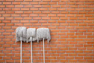 Close-up of metal against brick wall