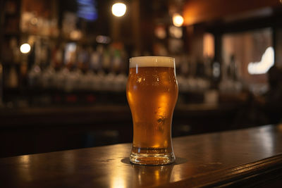 Close-up of beer glass on table