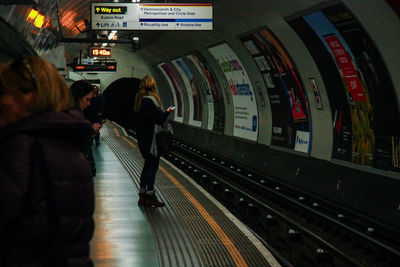 Rear view of people waiting in train