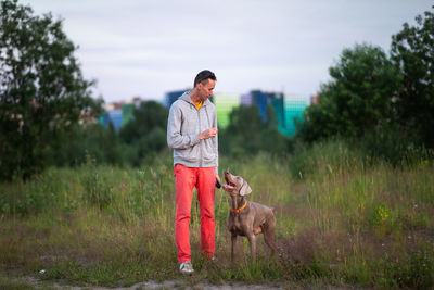 Man with dog on field