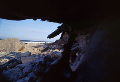 Close-up of beach against sky