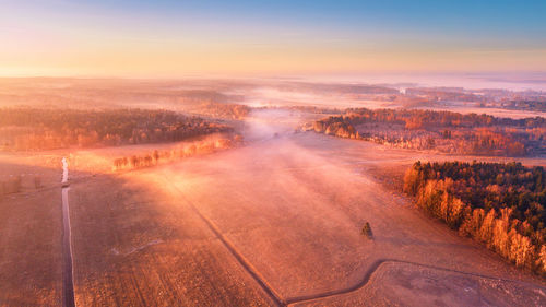 Aerial view of landscape against sky during sunset