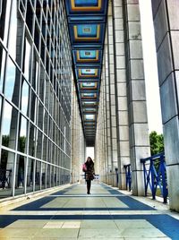 Rear view of woman walking in modern office building