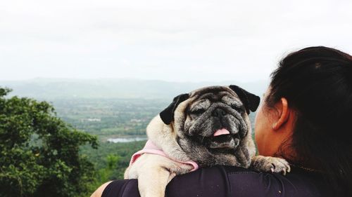 Man with dog against sky