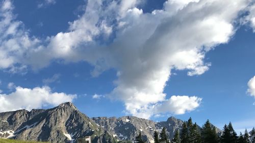 Low angle view of snowcapped mountains against sky