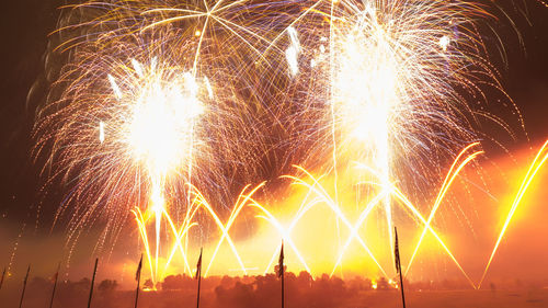 Low angle view of firework display at night