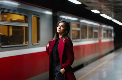 Full length of woman standing on train at railroad station