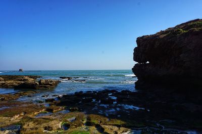 Scenic view of sea against clear blue sky