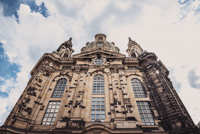 Low angle view of building against cloudy sky