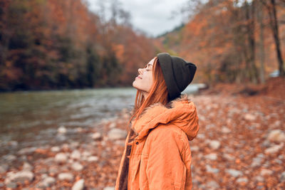 Side view of young woman standing on land