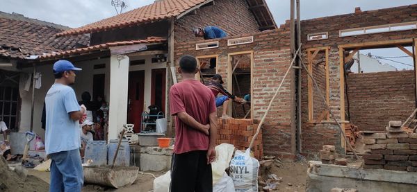 Rear view of people working at market