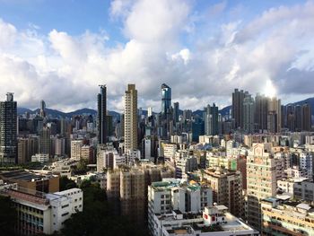 View of cityscape against cloudy sky