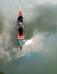 High angle view of people sailing in boat at lake