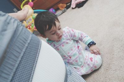 High angle view of cute boy sitting on floor