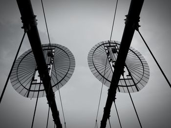 Low angle view of silhouette ferris wheel against clear sky