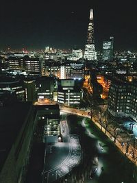 Illuminated cityscape against sky at night