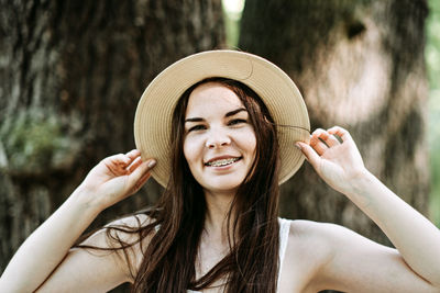 Candid portrait of beautiful happy smiling young woman with braces in summer park. outdoor portrait