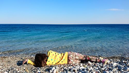 Scenic view of beach against clear blue sky