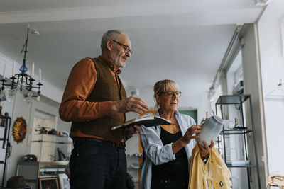 Side view of female friends working at home