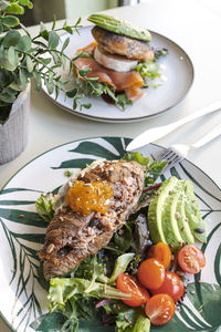 Breakfast plates with croissants with avocado and salad. brunch