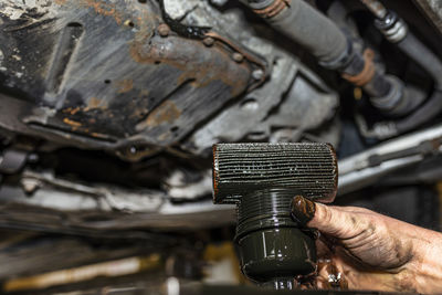 Close-up of man working on metal machine